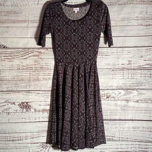 LuLaRoe Black Background with a tan & teal floral pattern.